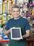 Salesman Showing Digital Tablet With Blank Screen In Pet Store