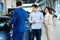 Salesman talking to a young couple at the dealership showroom