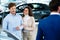 Salesman talking to a young couple at the dealership showroom