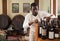 Salesman working in wine house arranging wine bottles