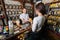 Salesperson giving product to female customer in tea store