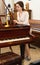 Saleswoman assistant in piano music store