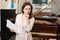 Saleswoman assistant in piano music store