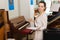 Saleswoman assistant in piano music store