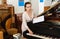 Saleswoman assistant in piano  store