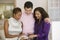 Saleswoman and Couple Examining Fabric Swatches in furniture store front view