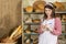 The saleswoman describes the plates for each type of bread. An attractive saleswoman counts the remaining bread for sale