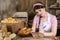 The saleswoman describes the plates for each type of bread. An attractive saleswoman counts the remaining bread for sale