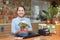 Saleswoman with flower at garden store