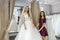 Saleswoman helping young bride in wedding salon