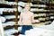 Saleswoman offering cloth in textile shop