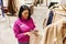 Saleswoman putting Special offer tag on jeans in shopping mall