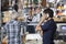 Saleswoman Selling Cheese To Customer At Shop