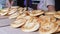 Saleswoman Sells Pastries, Bagels with Poppy Seeds on Open Counter Outdoors