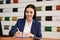 Saleswoman working at desk in dealership