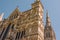 Salisbury Cathedral looking up at the Great West front with the spire in the background on a clear, sunny spring day