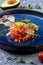 Salmon appetizer and chopped avocado in a plate