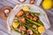 Salmon, Asparagus, Mushrooms and Lemon in Parchment. View from above, top studio shot.