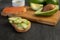 Salmon on bread slices gourmet appetizer with avocado. Fresh salmon   and avocado sandwich. Healthy food concept.