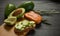 Salmon on bread slices gourmet appetizer with avocado. Fresh salmon   and avocado sandwich. Healthy food concept.