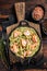 Salmon Bucatini pasta with creamy spinach sauce and fish fillet. Wooden background. Top view