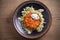 Salmon burger and cabbage salad in bowl on wooden table. Salmon fish cake and vegetables.