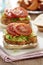Salmon burgers with lettuce, mayo dressing and tomatoes
