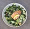 Salmon caesar salad in bowl