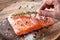 Salmon filet on a wooden carving board.