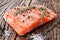 Salmon filet on a wooden carving board.