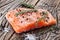 Salmon filet on a wooden carving board.