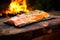 salmon fillet on cedar plank over glowing embers