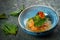 Salmon fillet ceviche with shiso leaves in a blue bowl