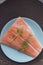 Salmon fillet with herbs on plate for diner