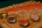 salmon fillet, pink salt, oil, colorful pepper and dried carrots in glass bowls