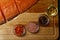 salmon fillet, pink salt, oil, colorful pepper and dried carrots in glass bowls