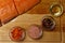 salmon fillet, pink salt, oil, colorful pepper and dried carrots in glass bowls