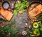 Salmon fillet on rustic kitchen table with fresh ingredients for tasty cooking and frying pan. Wooden background, frame, top view.