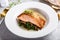 Salmon fillet served with sauteed greens and mushrooms