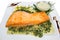 Salmon fillet with spinach and walnut sauce.