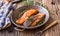 Salmon fillets. Grilled salmon, sesame seeds herb decorationon on vintage pan or black slate board.