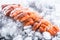 Salmon fillets portioned on ice and empty kitchen board