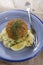 Salmon fishcake coated in brown breadcrumbs