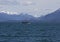 Salmon fishing boat in Southeast Alaska with mountains