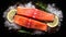 Salmon. Fresh raw salmon fish fillet with cooking ingredients, herbs and lemon on black background, top view