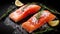 Salmon. Fresh raw salmon fish fillet with cooking ingredients, herbs and lemon on black background, top view