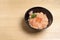 Salmon ikura don on the wood table.