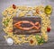 Salmon laid out in the shape of fish, around him spread the ingredients for making pasta, herbs spices on wooden rustic backgr