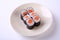 Salmon maki sushi on ceramic dish isolated on white background