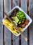 Salmon poke bowl with rice red quinoa edamame mango chopsticks